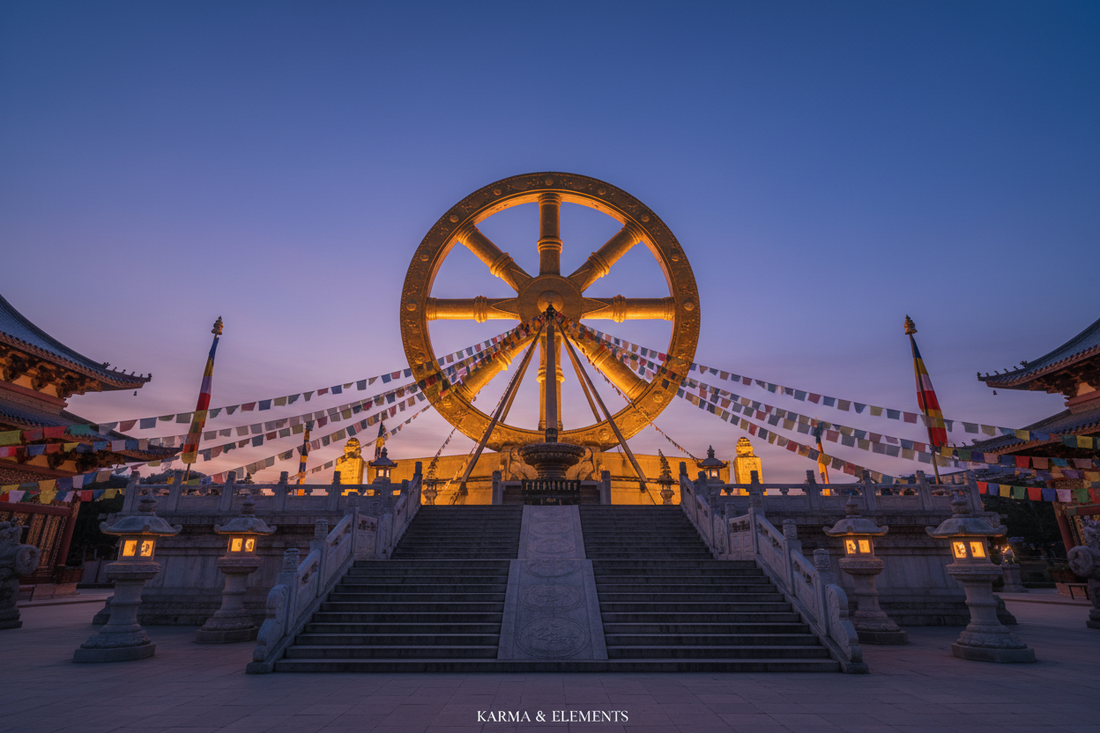  Golden Dharma Wheel glowing at a Buddhist temple at blue hour with prayer flags and lantern light — Karma & Elements